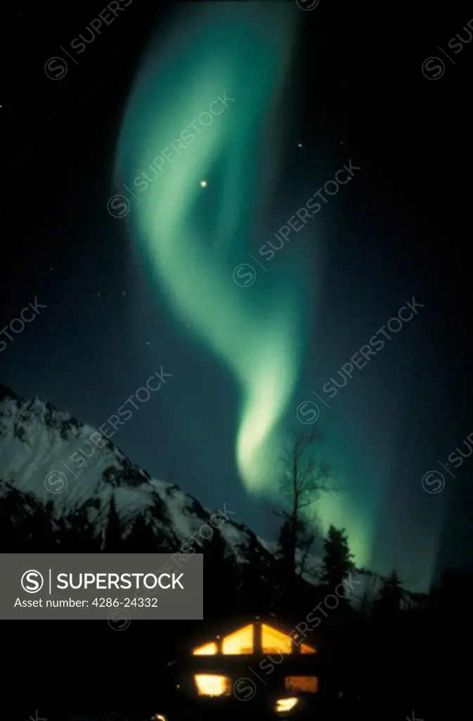 USA, Alaska, Matanuska Valley, Northern Lights (aurora borealis), cabin and Matanuska Peak, vertical image