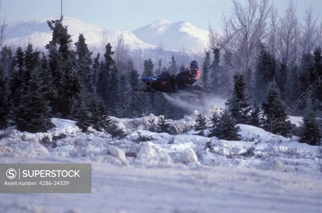 USA, Alaska, Anchorage, snowmobile races with snow capped peak
