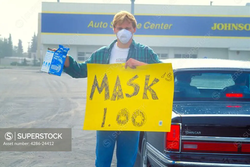USA, Alaska, Anchorage with volcano ash pollution from Mt Spur 1992 man selling face masks to filter the ash 