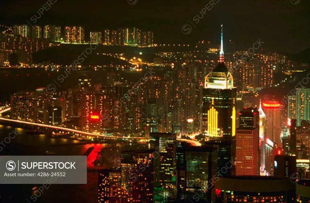 Aerial view of the lights of Hong Kong skyline and Hong Kong Harbor at night, China.