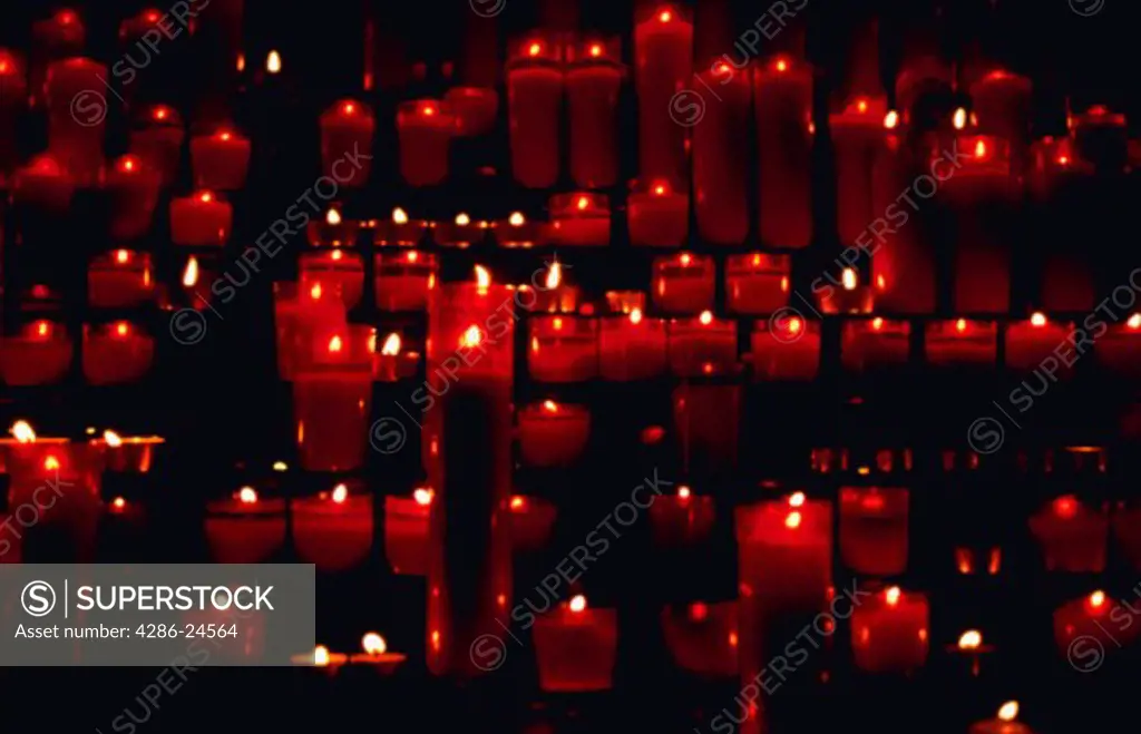 Red prayer candles in a Catholic cathedral in Barcelona, Spain.