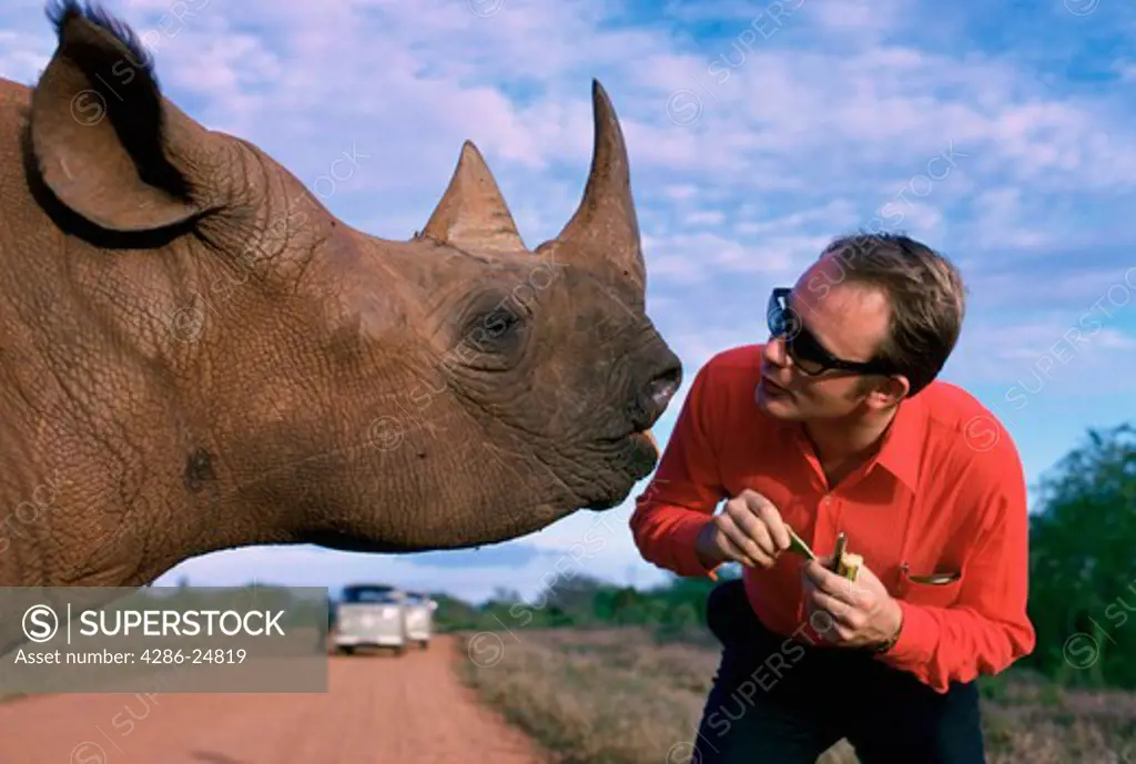 Man Head to Head with Rhinoceros