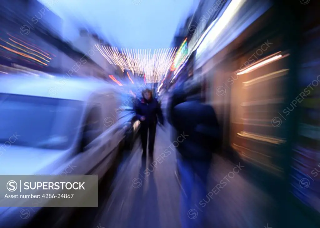 People walking on city street, pan blur