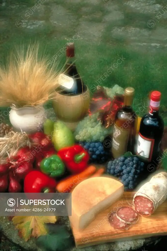 Still-life of bread, cheese and vegetables and wine.