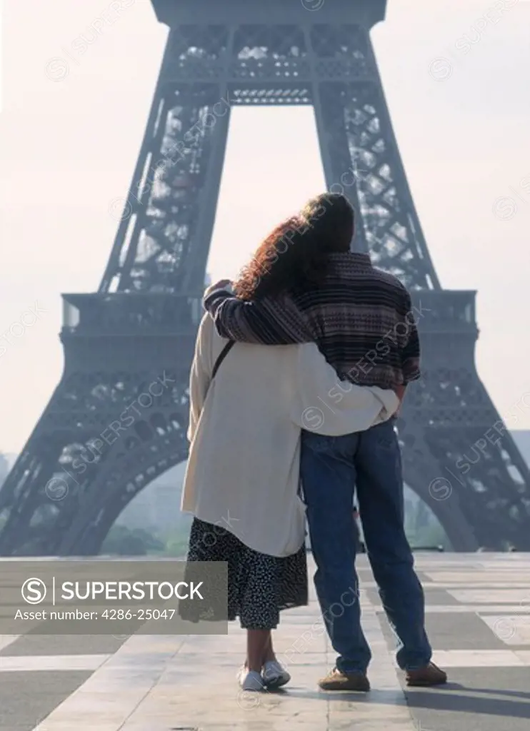 Couple standing at Palais de Chaillot looking at Eiffel Tower Paris France