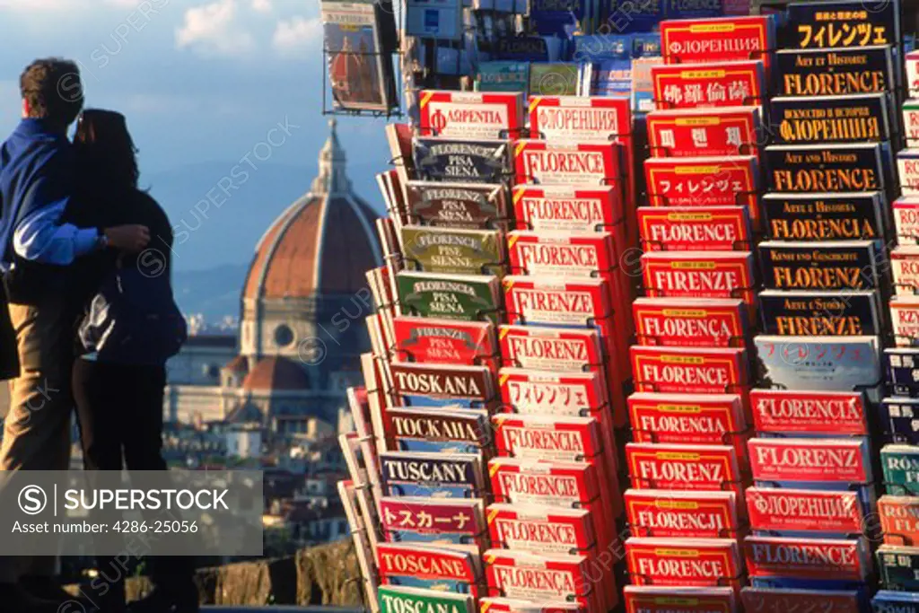 Couple at Piazalle Michelangelo looking at Santa Maria del Fiore Duomo with tourist books in multi languages Florence Italy