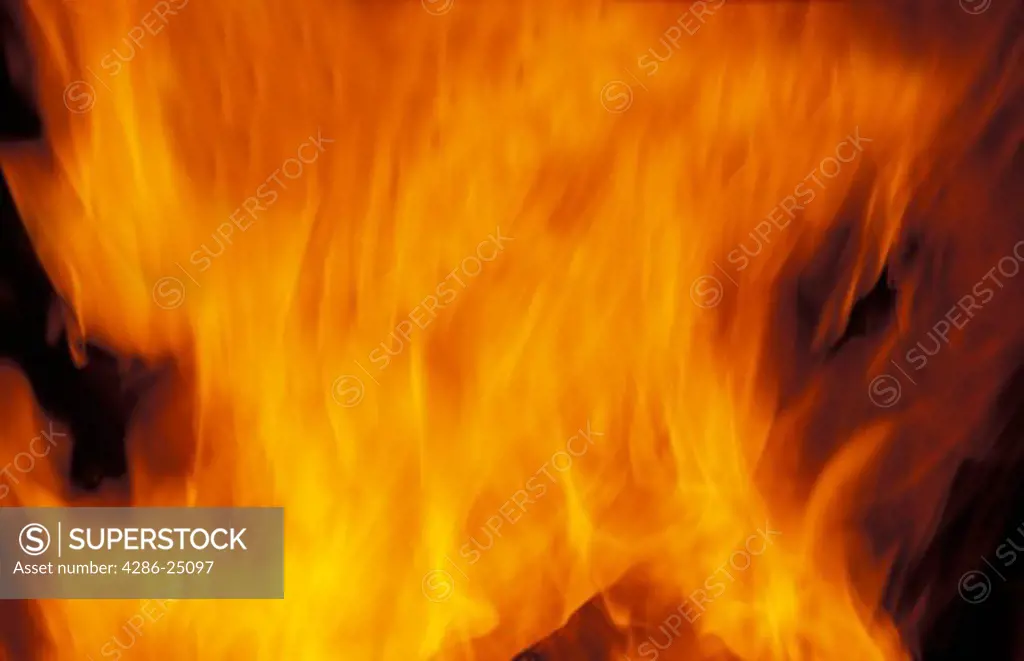 Burning logs in fireplace in mountain cabin