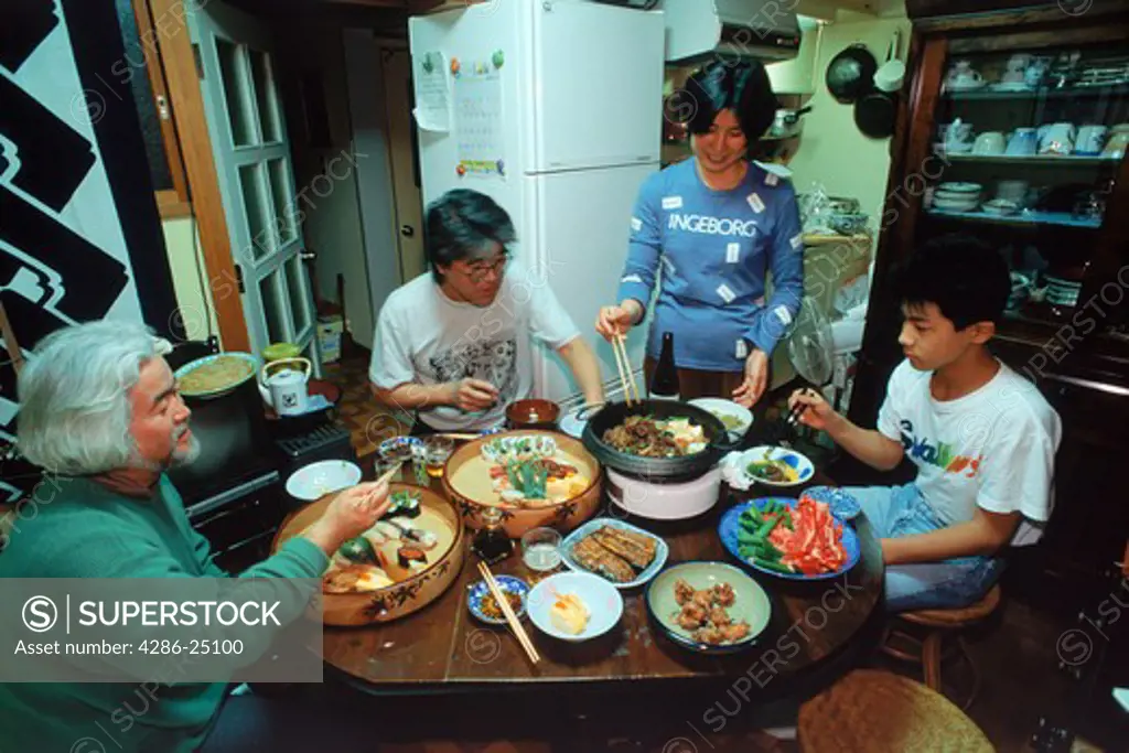 Japanese family eating typical food in small city apartment
