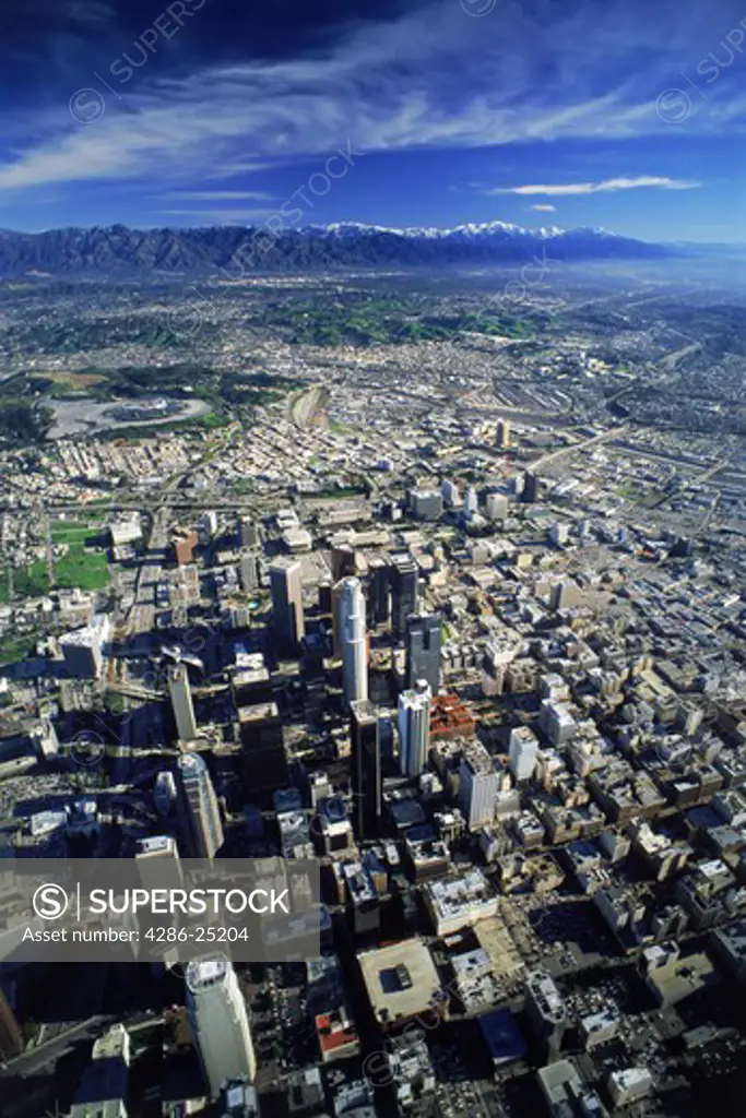 Aerial view of Downtown Los Angeles with snow covered San Gabriel Mountains.