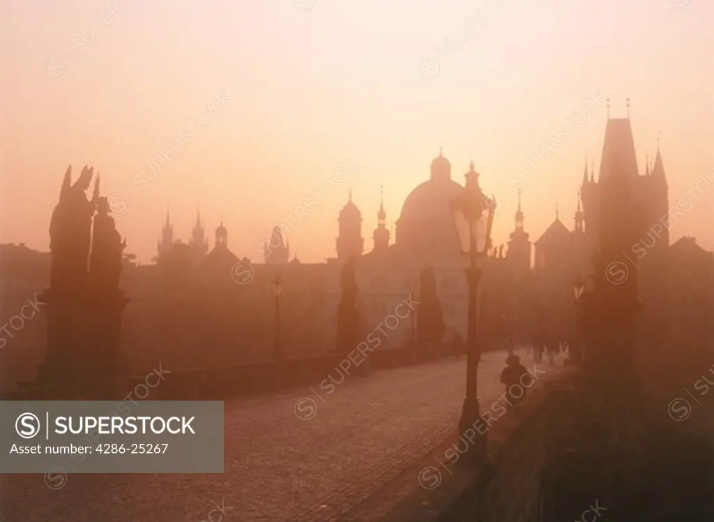 Charles Bridge and Baroque statues in morning mist
