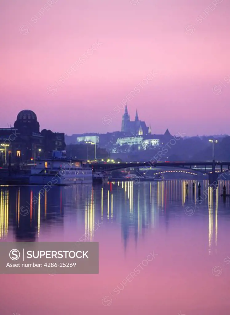 St Vitus Cathedral and Hradcany Castle reflecting off Vltava River at dusk