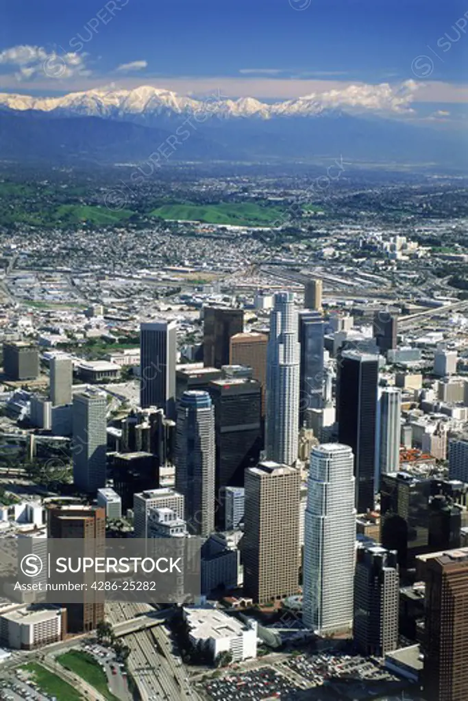 Aerial view of Los Angeles Civic Center with snow covered San Gabriel Mountains