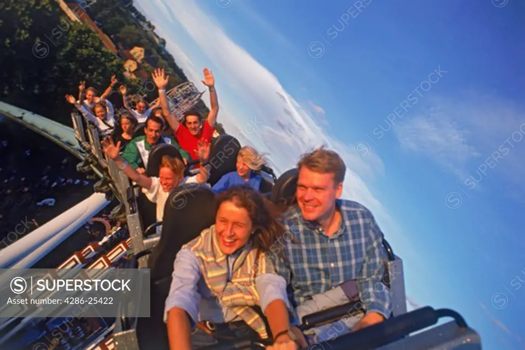 People flying around on roller coaster 