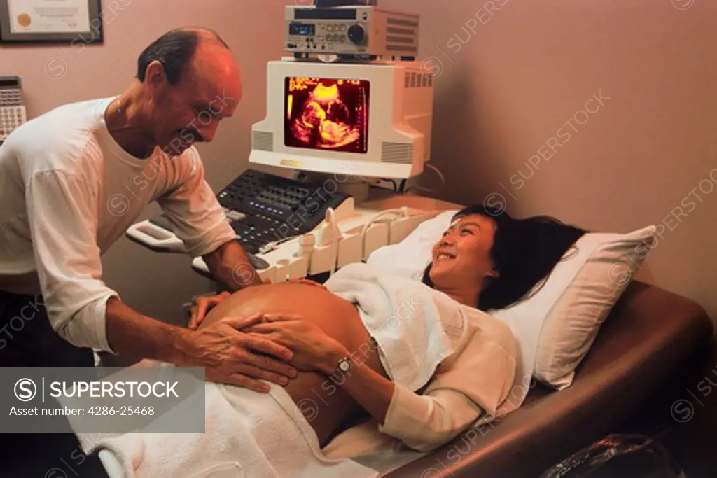 Husband and pregnant wife during ultrasound test