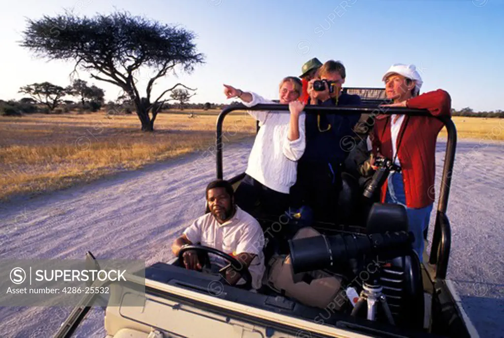 Jeep with tourist on safari in Zimbabwe