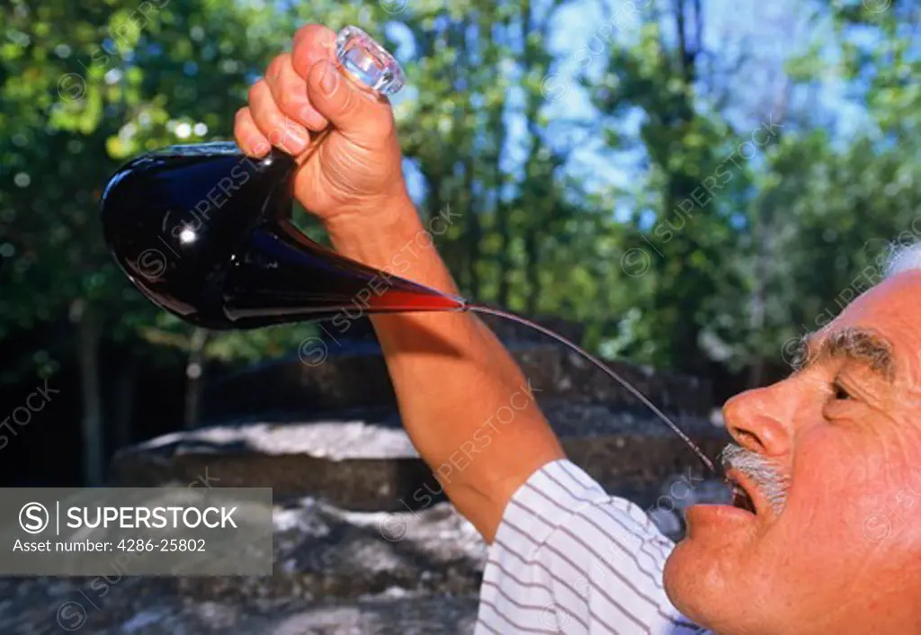 Traditional way of drinking wine from flask in Pyrenees Spain