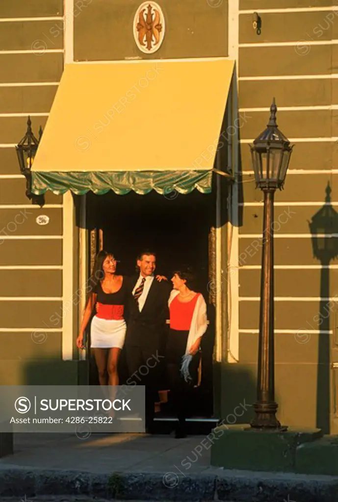 Man and two women leaving Tango Bar in Buenos Aires 