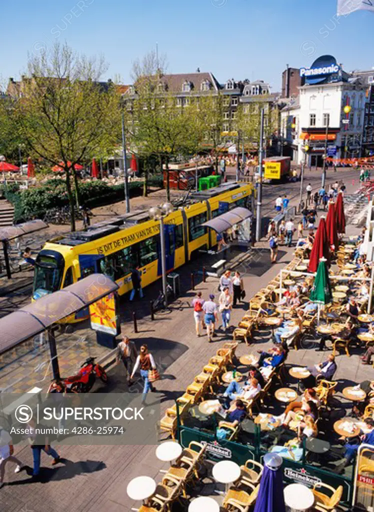 Trams and bikes and sidewalk cafes at Rembrandt Platz in Amsterdam