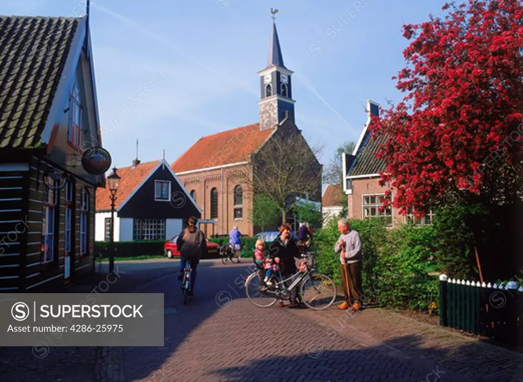 Church and people in village of Driehuizen in Schermer area of Holland