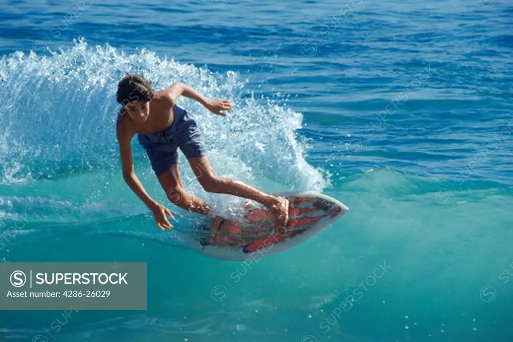 Young male kicking his boogey board through shore break