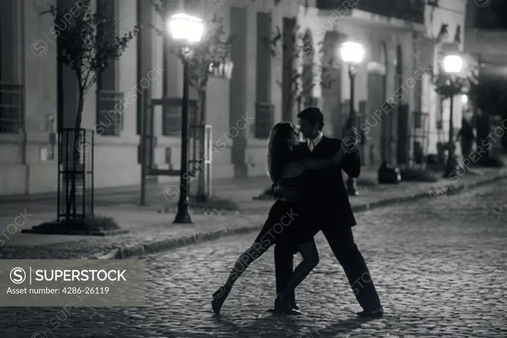 Couple dancing by lamplight on San Telmo street in Buenos Aires