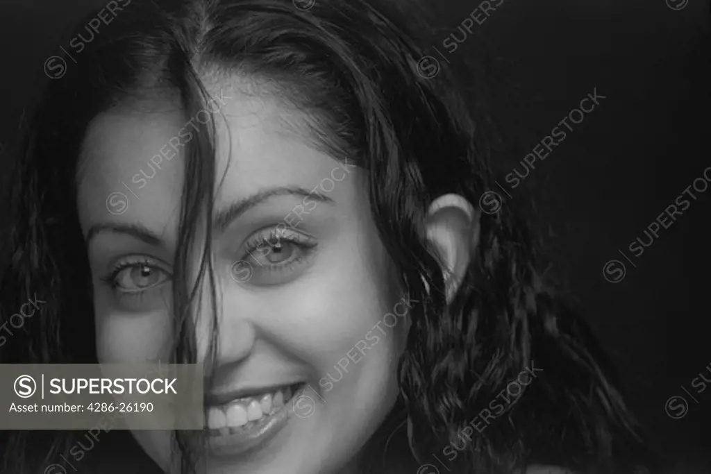 Persian woman with hair falling over smiling face