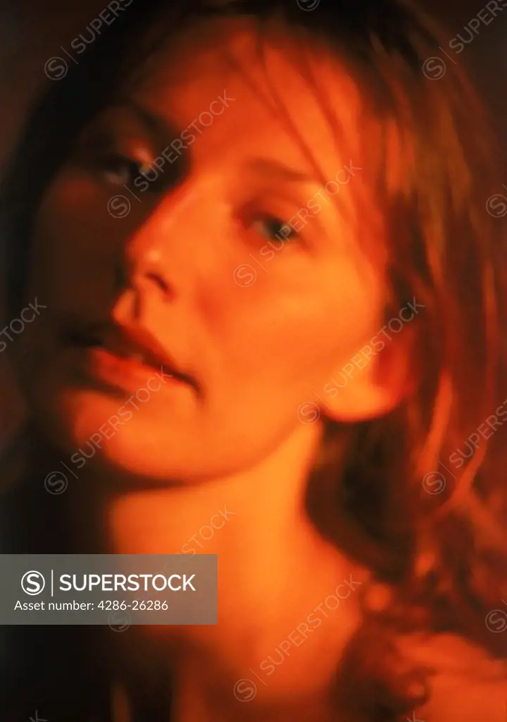 Woman with wet auburn hair and suggestive look