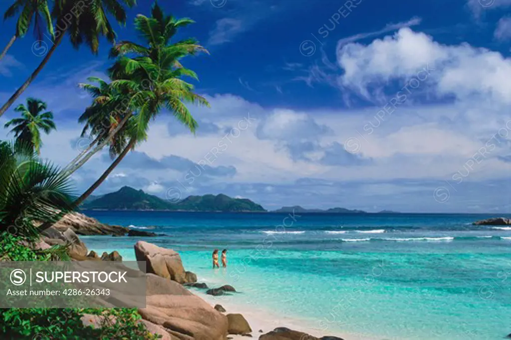 Two women in agua waters at Anse Severe on La Digue Island in Seychelles