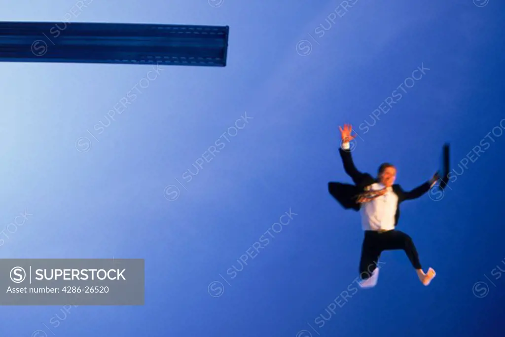 Crazy businessman jumping off diving board