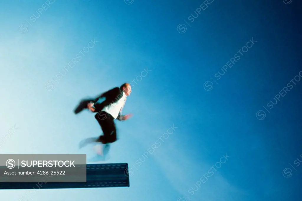 Businessman about to run off diving board