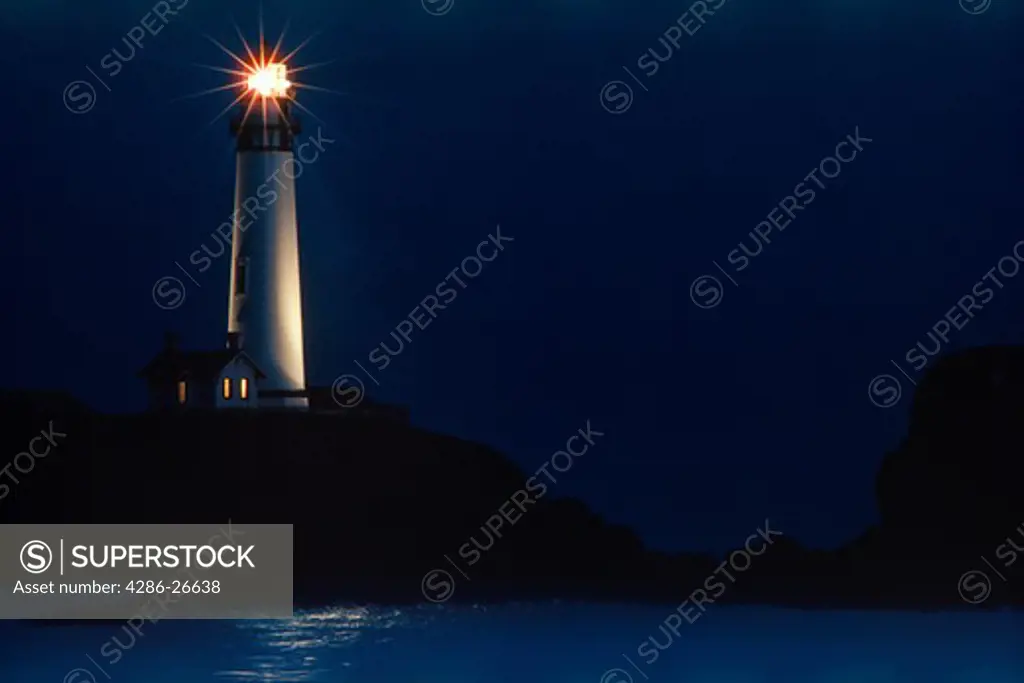 Pigeon Point Lighthouse casting its beam over Pacific Ocean at night