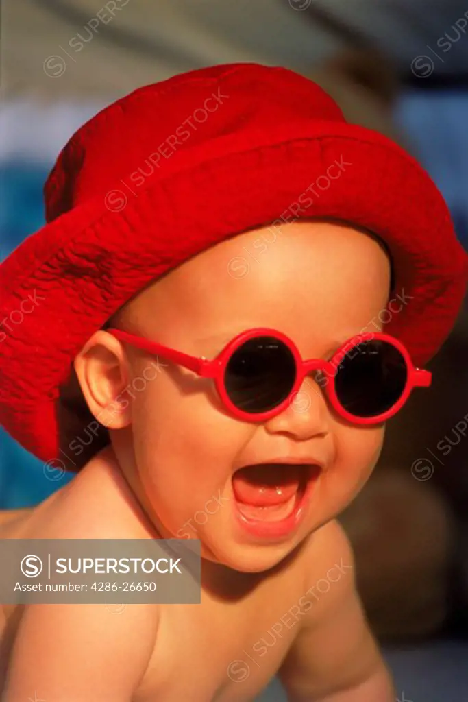 Baby looking cool with red hat and sunglasses