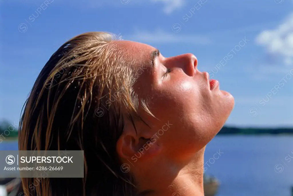 Woman facing warm summer sun