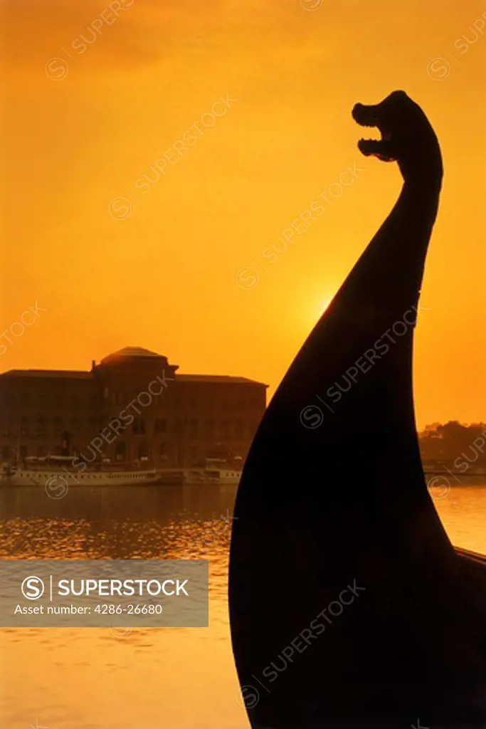Bow of Viking ship silhouetted at sunrise in Stockholm 