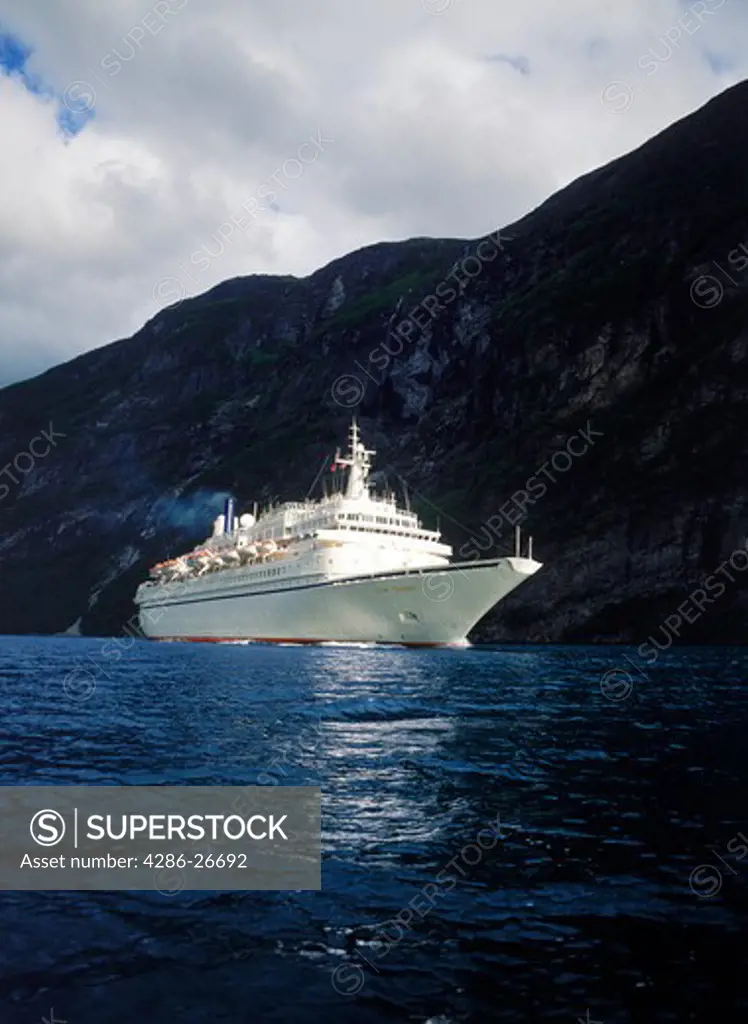 Cruise ship on Geirangerfjord along Norways jagged coast