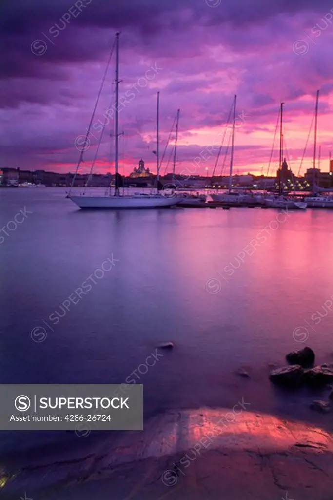 Crimson sunset over yachts in South Harbor of Helsinki