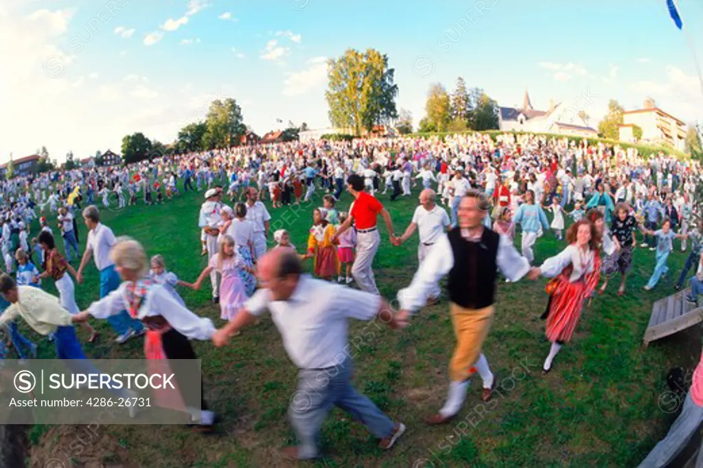People dancing around Maypole during Midsummer Celebrations at Leksand in Dalarna Sweden