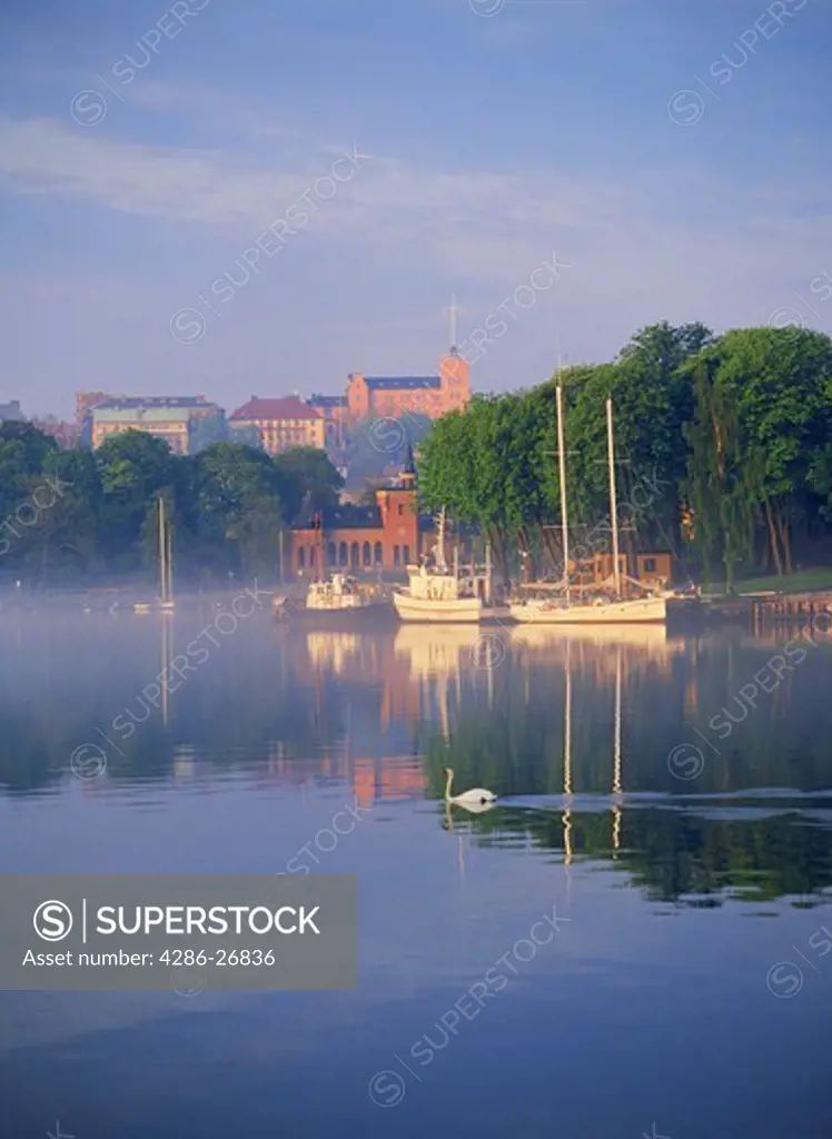 Boats anchored at Skeppsholmen at sunrise in Stockholm