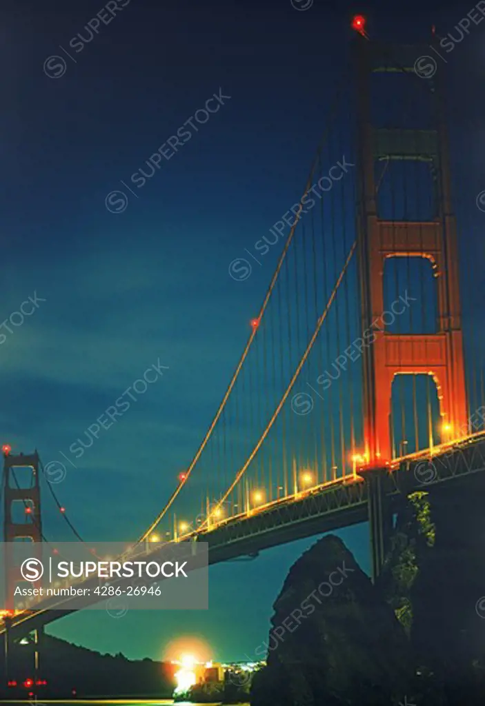 Lime Point Lighthouse under Golden Gate Bridge at night