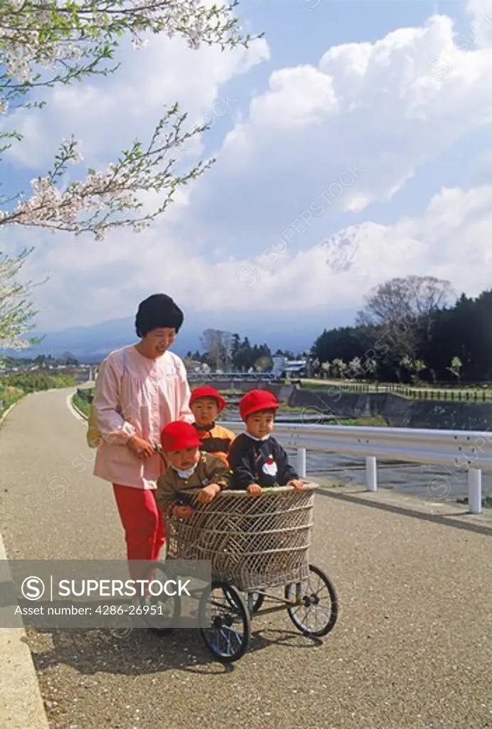 Mother with baby in stroller near Mount Fujiyama in Japan