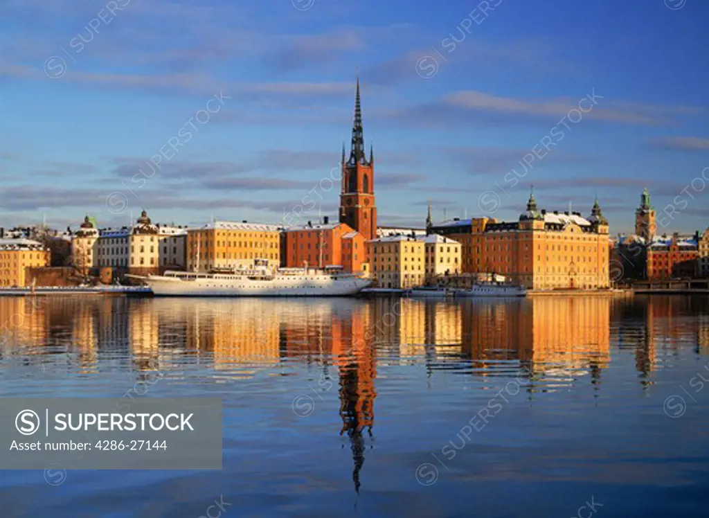 Church steeple in Old Town and Riddarholmen Island reflecting off Riddarfjarden in Stockholm in winter