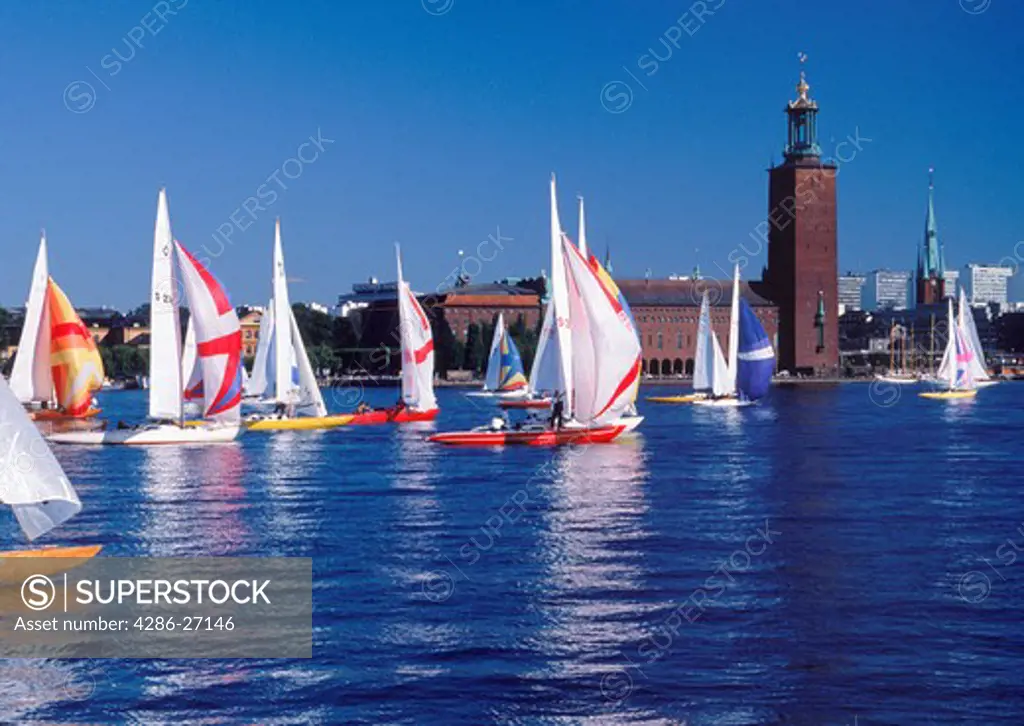 Sails on Riddarfjarden with Stockholm City Hall during Sailboat Day in September