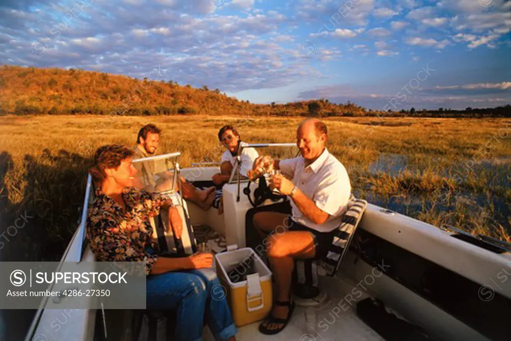 Couples having sunset drinks on Lake Kariba in Zimbabwe
