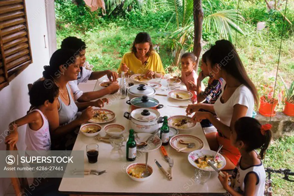 African Creole family eating home cooked meal in Seychelles