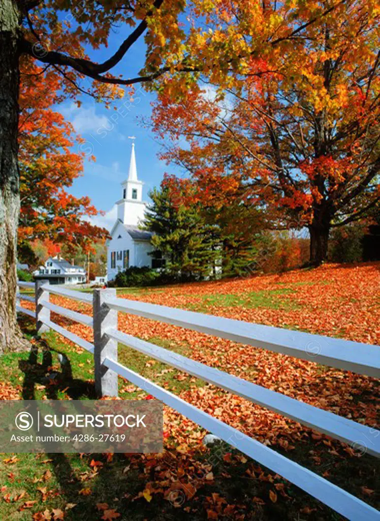 White picket fence and village church amid autumn colors at Fitzwilliam, New Hampshire
