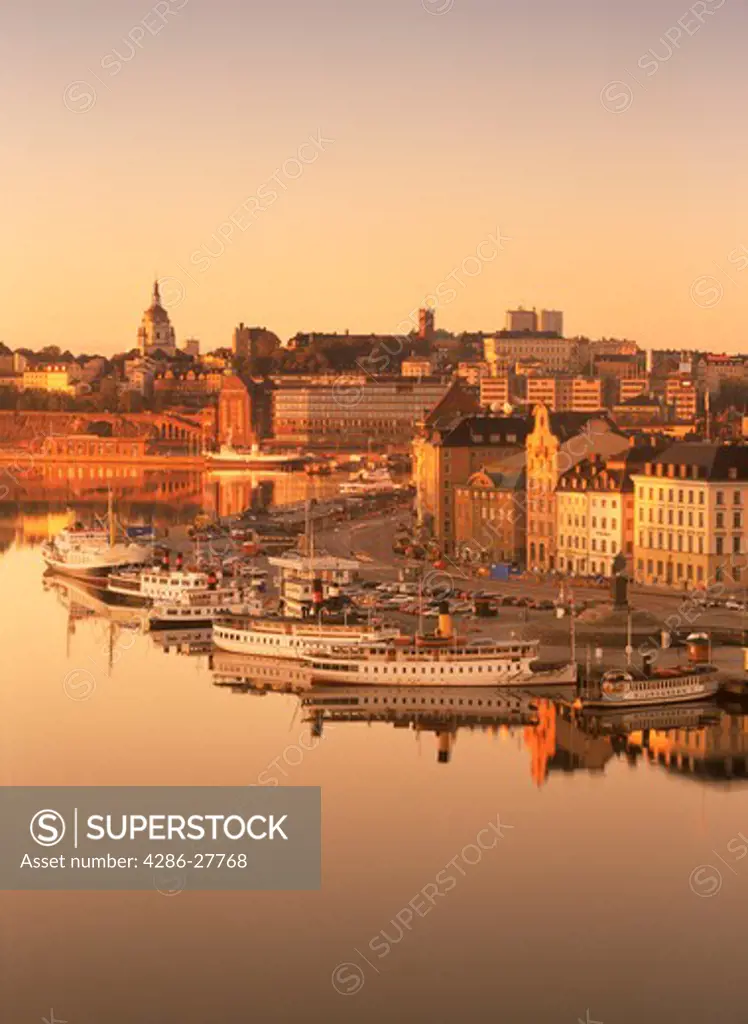 Ferryboats moored along Skeppsbron in Stockholm at sunrise