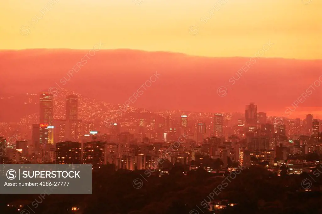 Caracas skyline at sunset with Park Central Building and barrios on hillsides