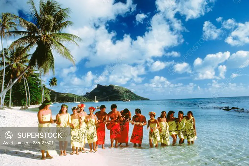 Traditional island dress of French Polynesians on Bora Bora beach in Society Islands