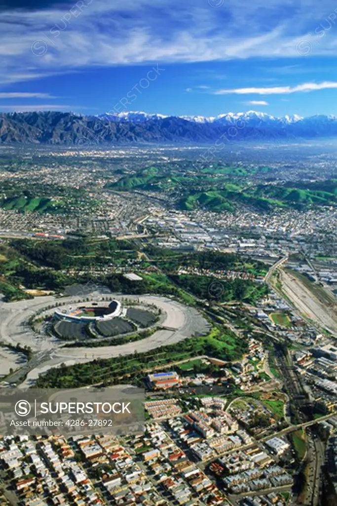 Aerial view of Downtown Los Angeles with snow covered San Gabriel Mountains and Dodger Stadium