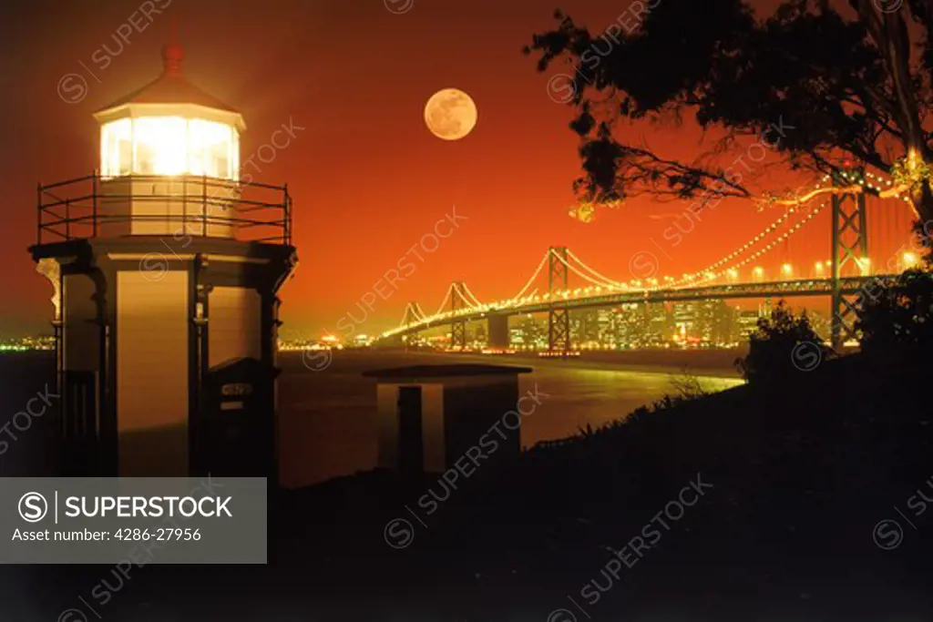 Yerba Buena Lighthouse on Yerba Buena Island with Bay Bridge and San Francisco skyline under full moon